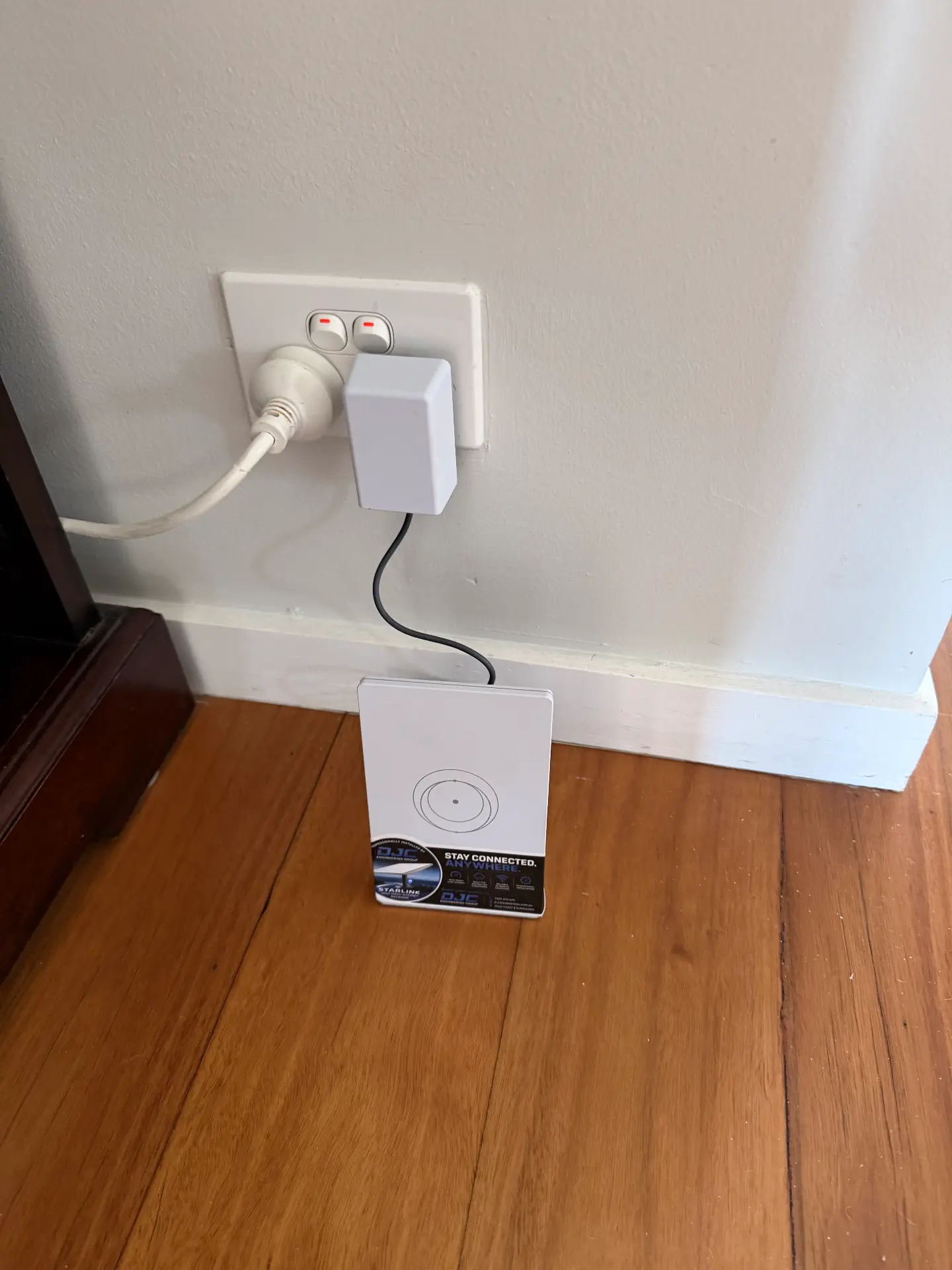 Starlink router and power supply installed at an indoor power point