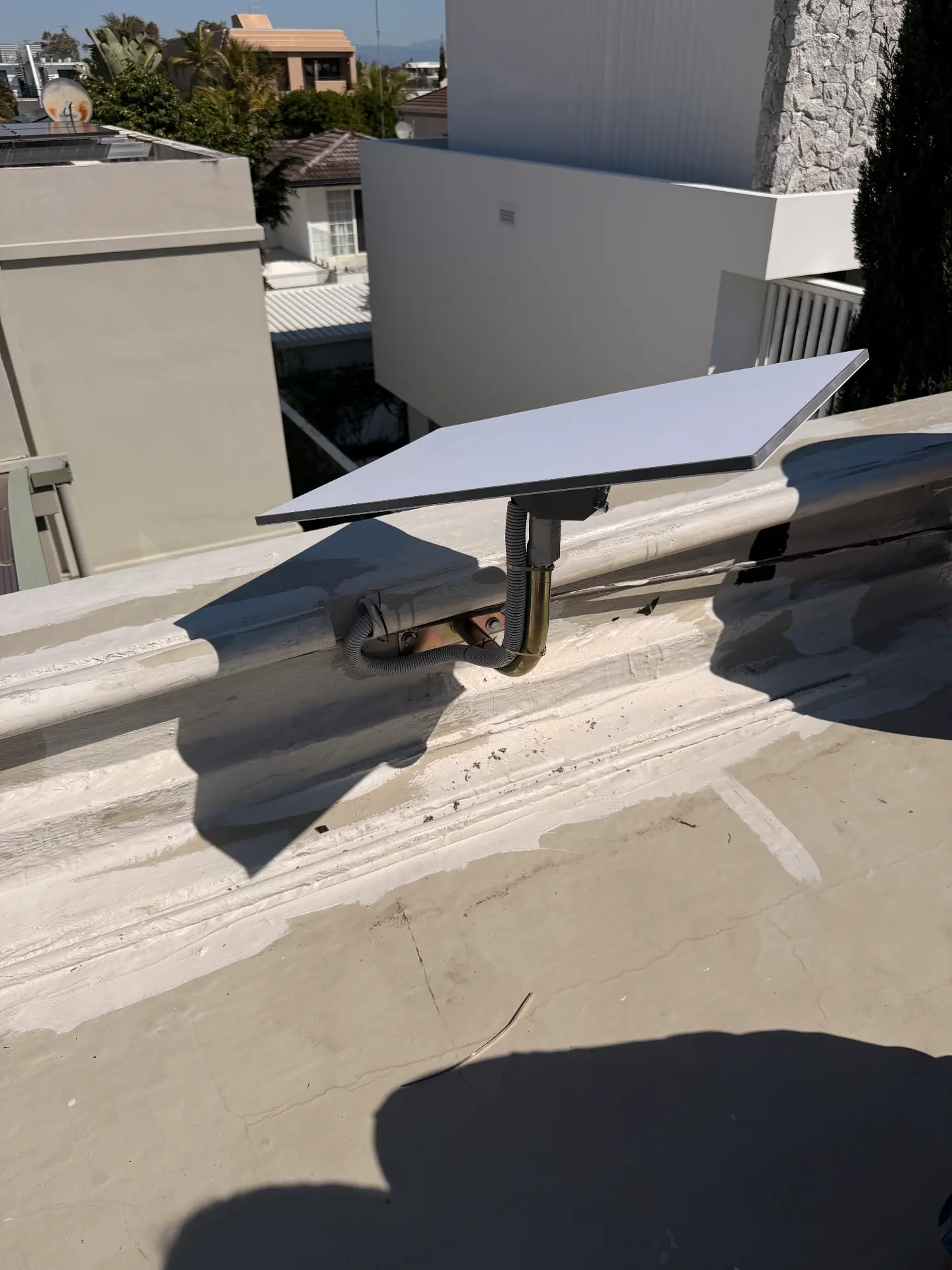 Starlink dish installed on a pole above a parapet wall