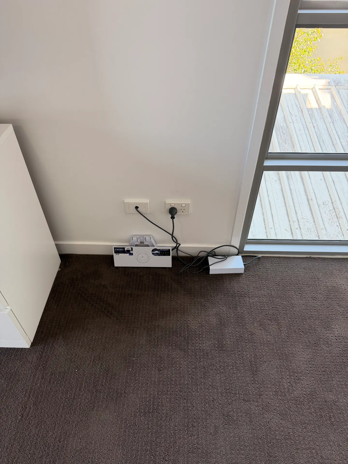 Router and power supply installed neatly against an office wall